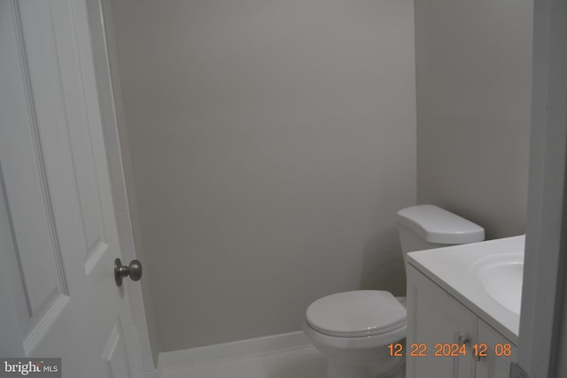 bathroom featuring tile patterned flooring, vanity, and toilet