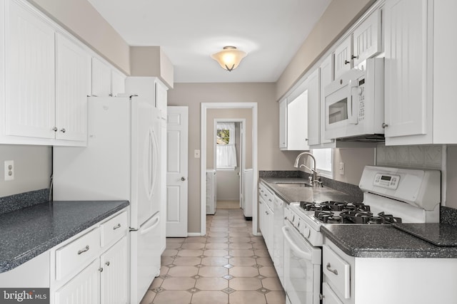 kitchen featuring white cabinets, sink, and white appliances