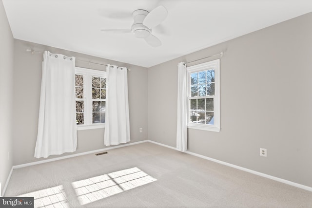 carpeted spare room with ceiling fan