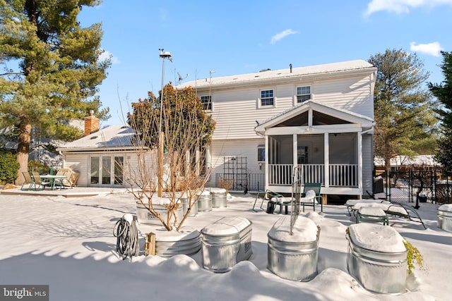 back of house featuring a sunroom and a patio