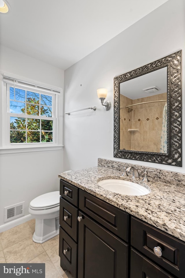 bathroom featuring tile patterned flooring, vanity, a shower with curtain, and toilet