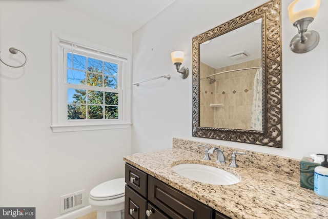 bathroom featuring toilet, vanity, and a shower with curtain