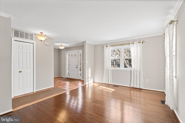 interior space featuring hardwood / wood-style floors and ornamental molding