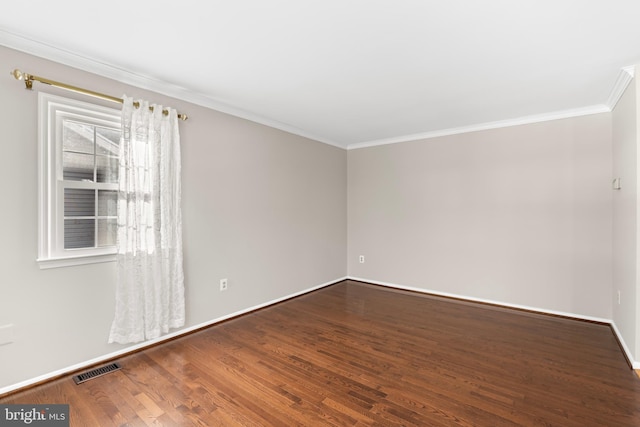 spare room with crown molding and hardwood / wood-style floors