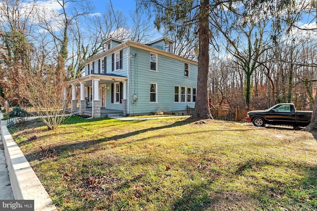 view of property exterior featuring a lawn and covered porch