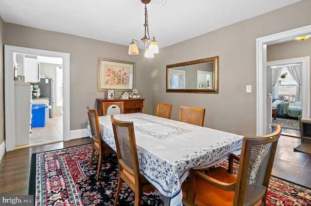 dining room with a chandelier and wood-type flooring