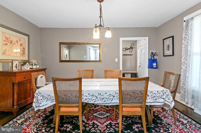 dining space with a chandelier and hardwood / wood-style flooring