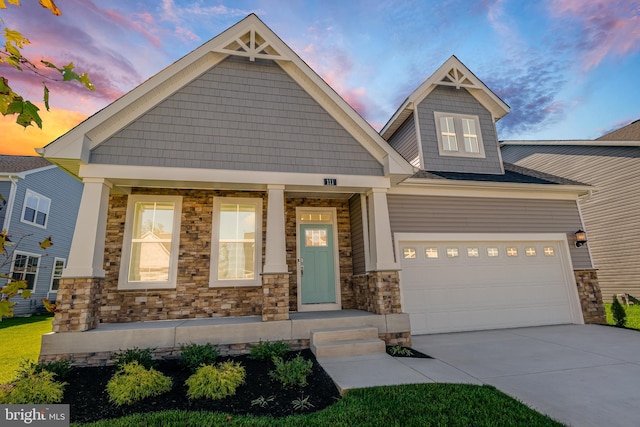 craftsman house with a garage and covered porch