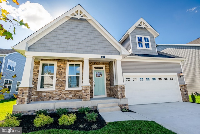 craftsman house with covered porch and a garage