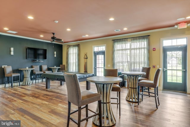 dining area featuring ceiling fan, crown molding, a healthy amount of sunlight, and light wood-type flooring