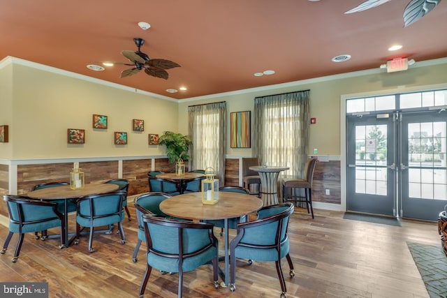 dining area featuring ceiling fan, crown molding, french doors, and hardwood / wood-style flooring