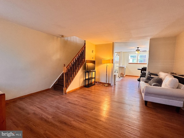 living room featuring hardwood / wood-style flooring and ceiling fan