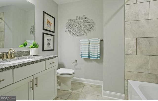 bathroom with toilet, vanity, tile patterned floors, and a bathtub