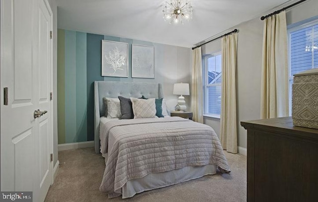 carpeted bedroom featuring a notable chandelier