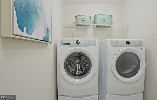 laundry area with washing machine and dryer