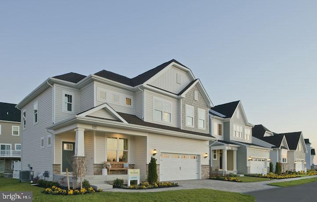 view of front of house with a garage, a front lawn, and cooling unit