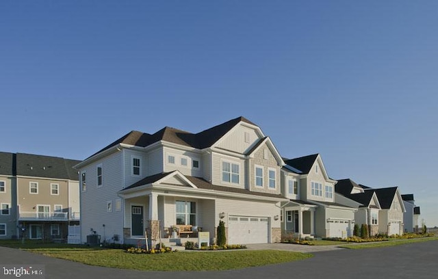 view of front facade with a garage and central air condition unit