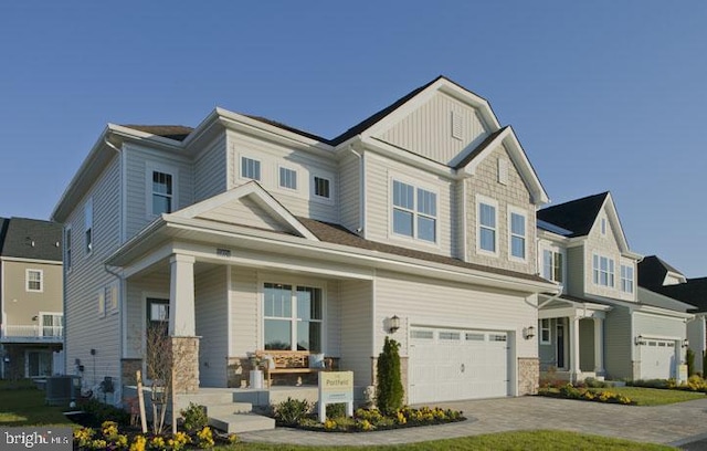 view of front of house with a garage and central AC