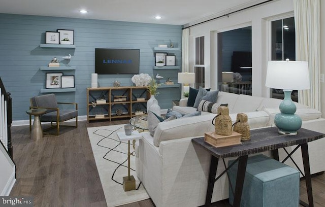 living room featuring wood walls and dark hardwood / wood-style flooring