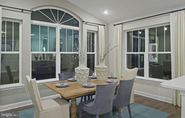 dining area featuring hardwood / wood-style floors and lofted ceiling