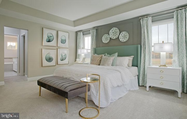 carpeted bedroom featuring ensuite bathroom