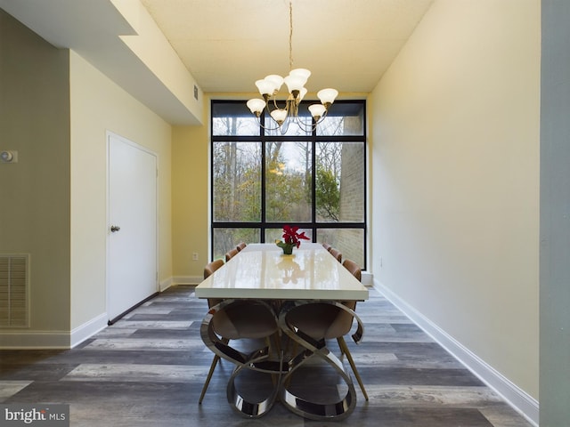 dining space with expansive windows, a notable chandelier, and dark hardwood / wood-style flooring