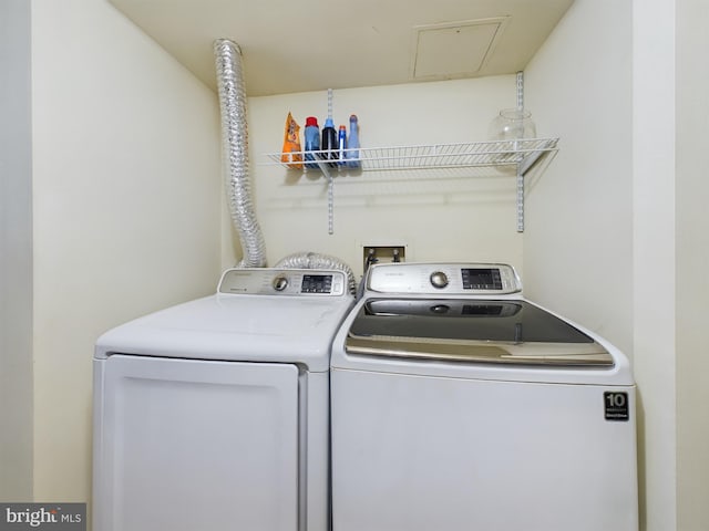 clothes washing area featuring separate washer and dryer