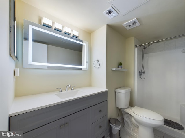 bathroom with vanity, toilet, and walk in shower