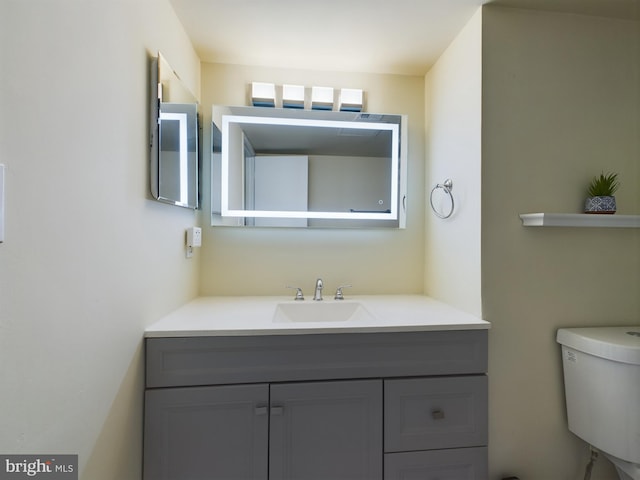 bathroom featuring vanity and toilet