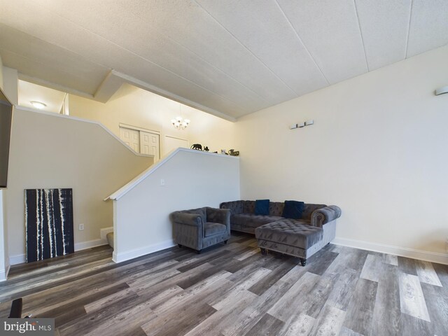 living room with hardwood / wood-style flooring and a notable chandelier