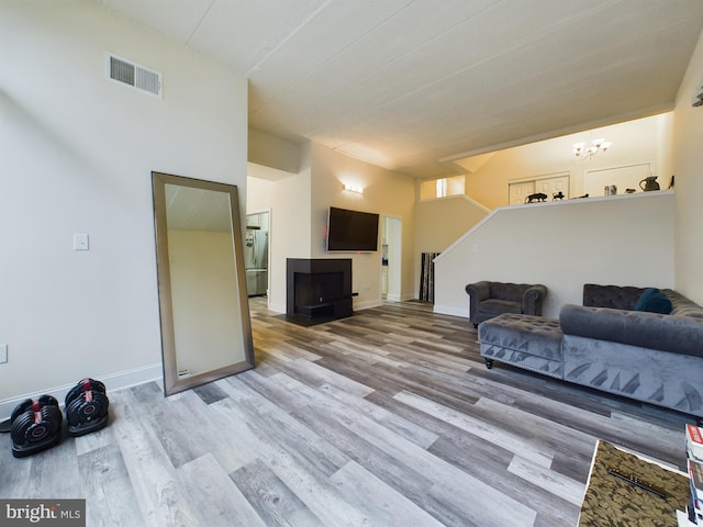 living room with a chandelier and light wood-type flooring