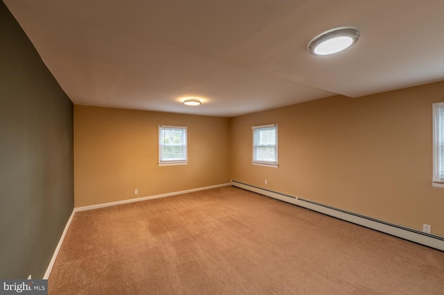 carpeted empty room featuring baseboard heating