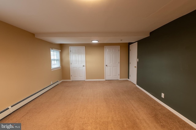 unfurnished bedroom featuring baseboard heating and carpet floors