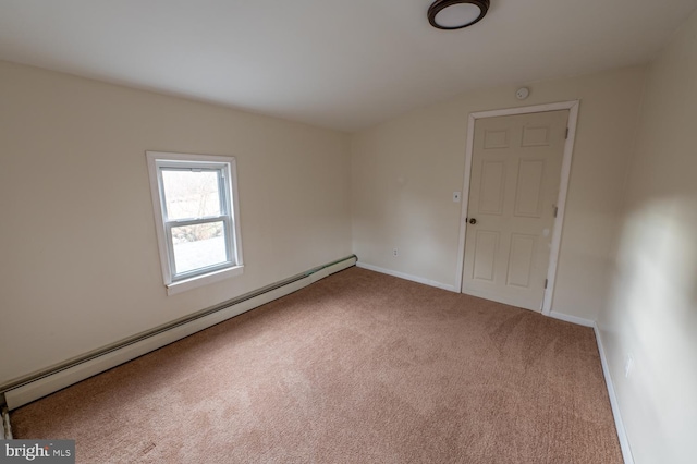 carpeted spare room with a baseboard radiator