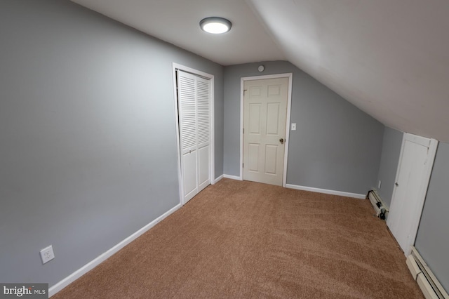 additional living space with carpet, a baseboard radiator, and vaulted ceiling