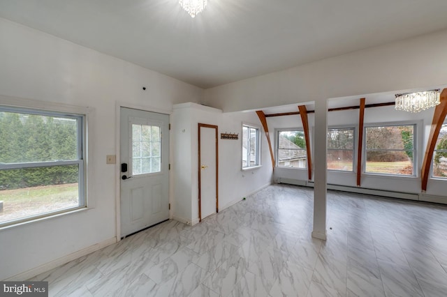 entryway featuring a wealth of natural light and a notable chandelier