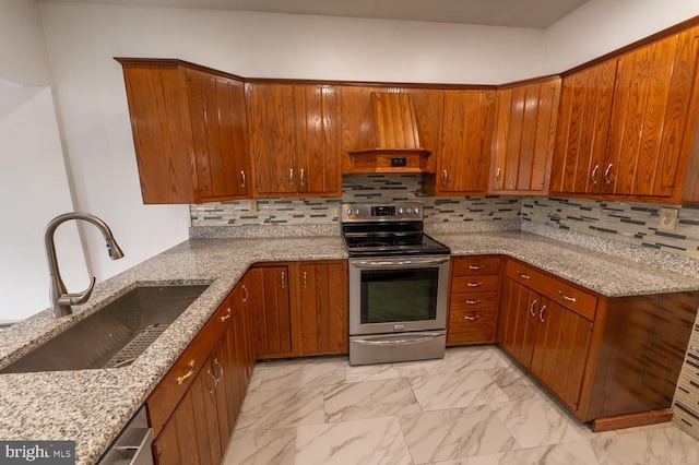 kitchen featuring custom exhaust hood, backsplash, stainless steel range with electric cooktop, sink, and light stone counters