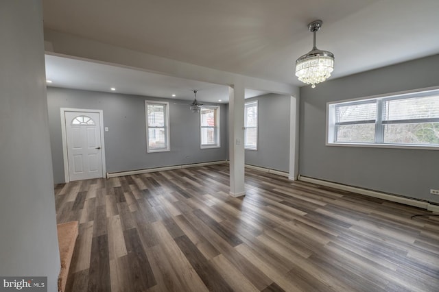 entryway featuring baseboard heating, dark hardwood / wood-style floors, and a notable chandelier