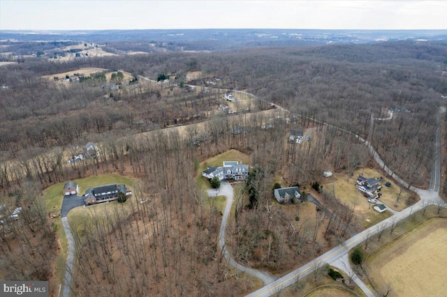 birds eye view of property featuring a view of trees