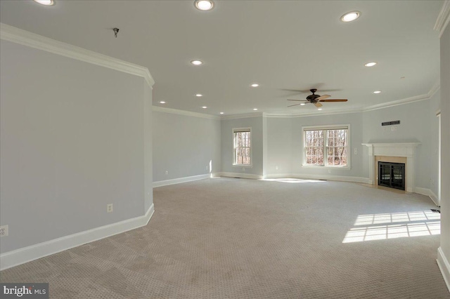 unfurnished living room with baseboards, crown molding, and a glass covered fireplace