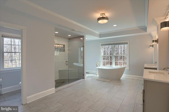 full bath with a stall shower, a freestanding bath, crown molding, and vanity