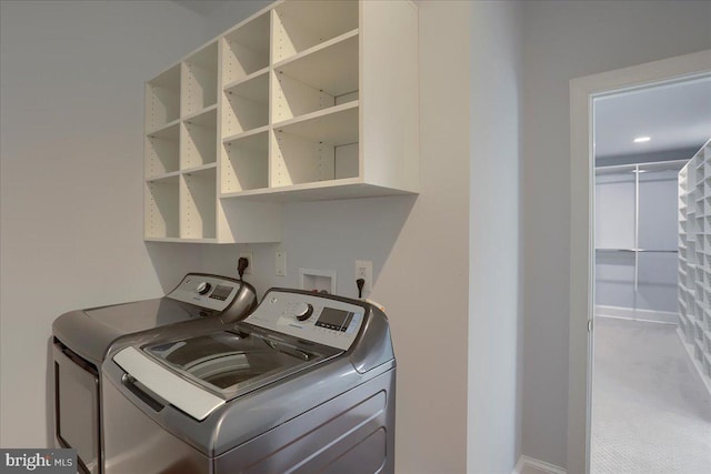 laundry area featuring laundry area, baseboards, and washer and dryer