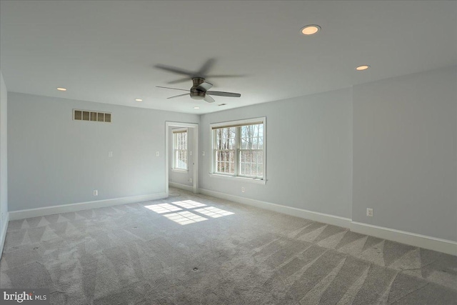 carpeted spare room featuring baseboards, visible vents, a ceiling fan, and recessed lighting