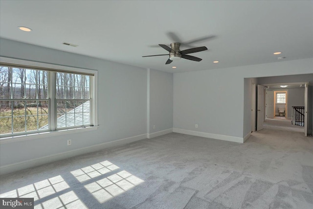 spare room featuring ceiling fan, recessed lighting, light carpet, visible vents, and baseboards