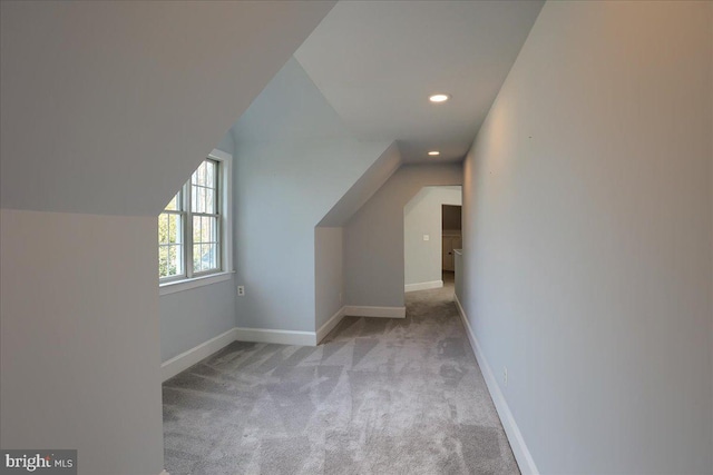 additional living space featuring carpet floors, recessed lighting, baseboards, and lofted ceiling