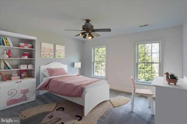 bedroom with a ceiling fan, visible vents, and baseboards