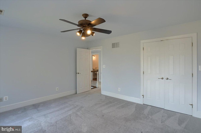 unfurnished bedroom with baseboards, a closet, visible vents, and carpet flooring