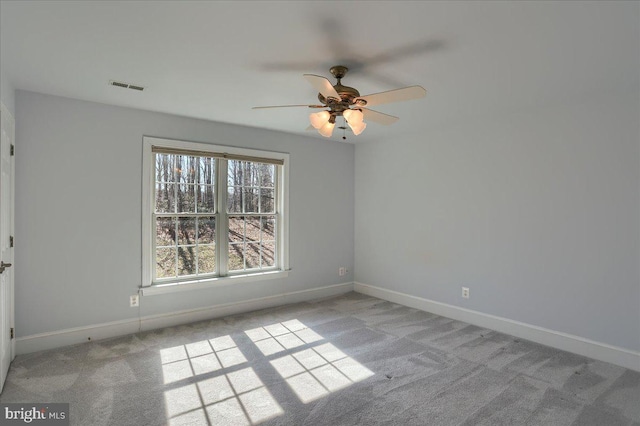 unfurnished room featuring baseboards, visible vents, and light colored carpet