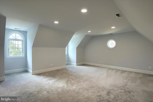 bonus room featuring carpet floors, visible vents, and baseboards