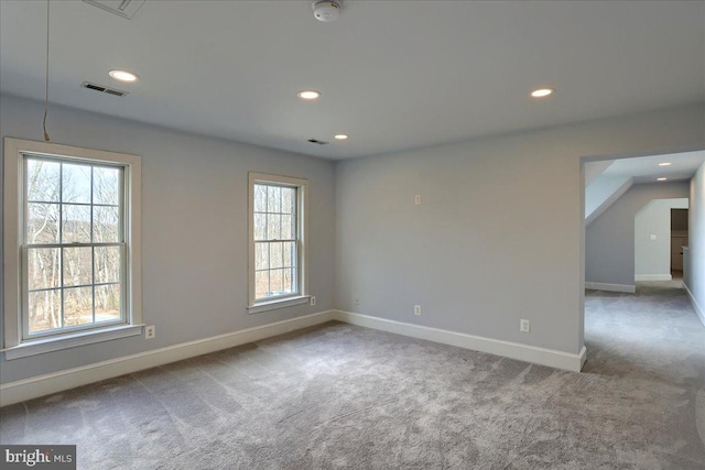 spare room with recessed lighting, baseboards, visible vents, and carpet flooring